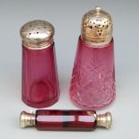 A hallmarked silver mounted cranberry glass sugar shaker,