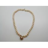 A two strand pearl bracelet with 9ct gold clasp in the form of a flower set with a further pearl