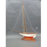 A 1920's vintage pond yacht on wooden stand,