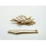 A 9ct gold brooch in a stylised foliate design set with pearls and a 9ct gold brooch set with