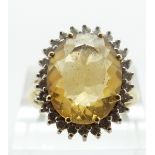 An 18ct gold ring set with a citrine and diamonds, size Q/R, 8.