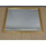 A large gilt framed mirror with bevelled edge,