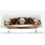 A 9ct gold ring set with garnets and pearls, size O, 2.