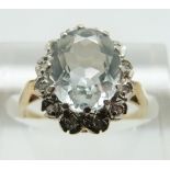 A 9ct gold ring set with an oval aquamarine surrounded by diamonds, size L/M, 2.