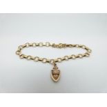 A 9ct gold bracelet and charm reading 'knock at my heart', 7.