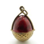 A Russian enamel egg pendant in a red enamel basket, marked 84,
