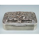 A continental white metal engine turned cigarette or similar dressing table box with plated relief