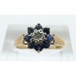 A 9ct gold ring set with a diamond and sapphires
