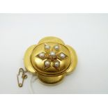 A Victorian yellow metal brooch set with seven pearls in a flower design,