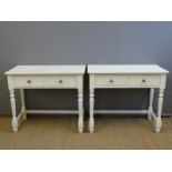 A pair of painted pine two drawer side tables,