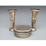 A white metal travelling dressing table pot and two hallmarked silver trumpet vases, height 12.