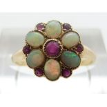 An 18ct gold ring set with opals and rubies, size M, 1.
