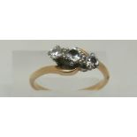 An 18ct gold ring set with three diamonds in a platinum twist setting,