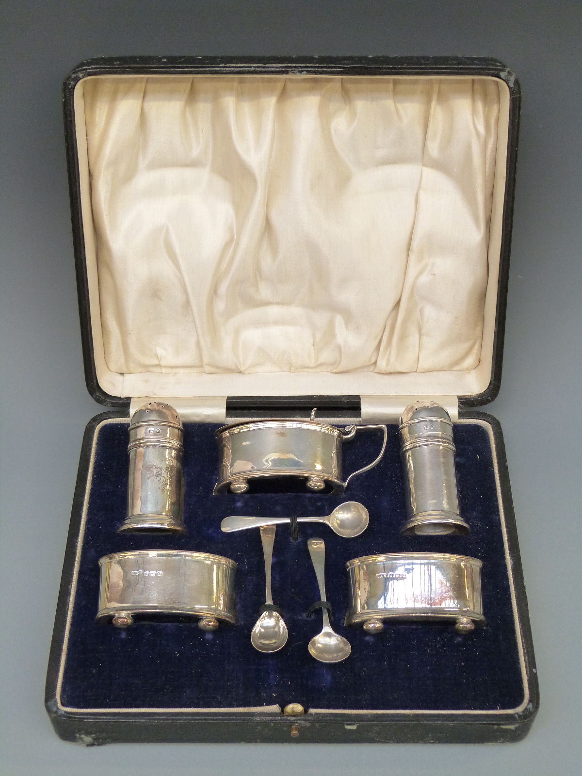 A George V five piece hallmarked silver cruet set,