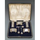 A George V five piece hallmarked silver cruet set,