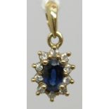A 9ct gold pendant set with a sapphire and diamonds