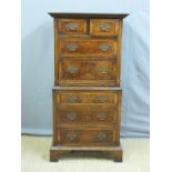 A small walnut chest on chest with brushing slide,