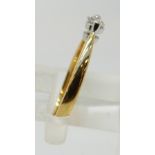 An 18ct gold ring set with a diamond of approximately 0.