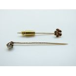 A late Victorian stick pin set with a round cut diamond (0.25ct) and a 9ct gold stick pin, 2.