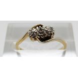 An 18ct gold ring set with three diamonds in a twist setting, Size M, 2.
