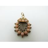 A Victorian pendant set with coral cabochons and seed pearls