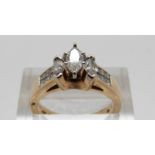 A 14ct gold ring set with three marquise cut diamonds and further square cut diamonds, size M, 5.
