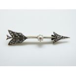 A Victorian brooch set with old cut diamonds and a pearl in the form of an arrow
