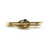 A 15ct gold brooch set with a sapphire, 3.
