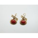 A pair of yellow metal earrings set with coral cabochon to each, 3.