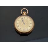 An 18k yellow metal cased ladies fob watch with engraved foliate decoration, marked to case 18k,