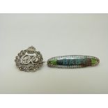 A Charles Horner silver baby brooch set with blue and green enamel reading 'Baby' and a silver GR