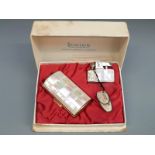A boxed Ronson lighter set with tiled mother of pearl decoration and matching cigarette case,