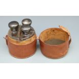 A leather cased travelling or hunting set comprising three bottles, each with hallmarked silver lid,