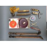 A quantity of tools including spring balances, measuring tapes,