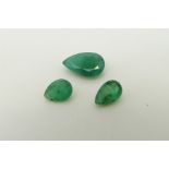 Three pear cut emeralds, the largest approximately 0.