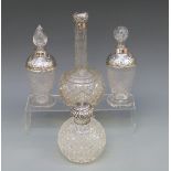 Four silver topped cut glass scent bottles including a hobnail cut example