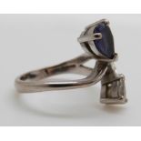 An 18ct white gold ring set with a pear cut tanzanite and a pear cut diamond, size I/J, 4.