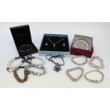 A collection of jewellery to include four silver bracelets, one set with quartz,