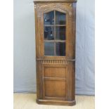 An Old Charm style glazed oak corner cupboard,