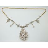 A Belle Epoque diamond set necklace / brooch in a foliate and floral design,