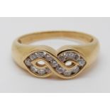 An 18ct gold ring set with diamonds in a twist, 3.