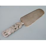 A white metal cake slice with pierced foliate handle, marked Peru 925, length 20cm,