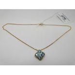 A 9ct gold pendant set with topaz and diamonds on 9ct gold chain