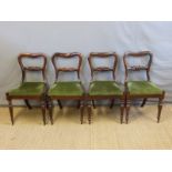 A set of four Victorian rosewood dining chairs with turned and carved front legs