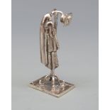 A white metal novelty coat rack with hat and articulated coat, marked with star 175 AR 925,