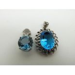 A 9ct white gold pendant set with topaz and diamonds and a 9ct white gold pendant set with topaz