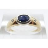 A 9ct gold ring set with an oval sapphire and two diamonds, size M, 2.