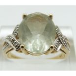 A 9ct gold ring set with an oval cut topaz and two diamonds, size Q, 3.