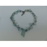 An aquamarine necklace made up of irregular pieces and natural rough sections