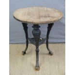 A pub table with cast iron base decorated with ladies faces